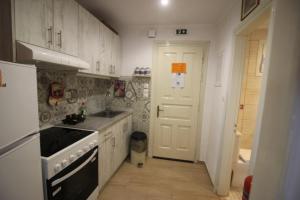 a kitchen with a sink and a stove top oven at Niky's cottage in Paleokastritsa