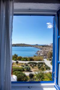 a window with a view of a body of water at Hidden Serenity in Mikonos