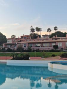 a pool of water with buildings in the background at Lighthouse Apartment in Luz
