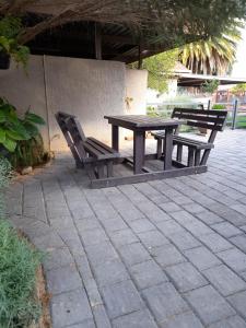 uma mesa de piquenique e 2 cadeiras num pátio em Vita Nova em Bloemfontein