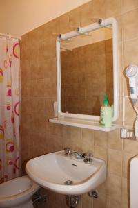 a bathroom with a sink and a mirror at Hotel Milano in Como