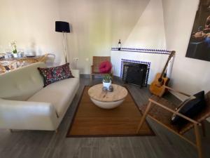 a living room with a couch and a fireplace at Detached holiday house, 2 bedrooms, private garden, pool in Alhaurín de la Torre