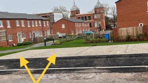 Duas flechas apontam para uma rua com casas. em Erasmus House - 3 Bedrooms - City Centre, Netflix, WIFI, Free Private Parking em Derby