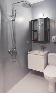 a bathroom with a shower and a toilet and a sink at AMADINA GARDEN - Bed & Breakfast or Half Board in Lozenets
