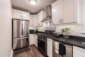 a kitchen with white cabinets and stainless steel appliances at Lake apt 5 minutes to downtown, pet friendly in St. Petersburg