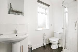 a white bathroom with a sink and a toilet at Contractor Group relocation accommodation Birmingham in Birmingham +25 photos