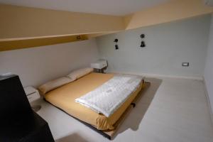 A bed or beds in a room at Green House Morin - San Pietro