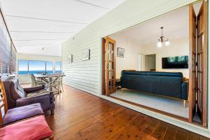 a living room with a couch and a table at 12 Bluewater Drive Narooma in Narooma