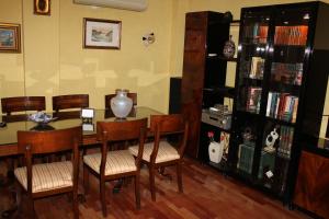 a dining room with a table and chairs and a book shelf at Villa Granada Motril in Motril