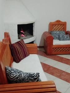a living room with two beds and a fireplace at Hostal la nube in San Cristóbal de Las Casas