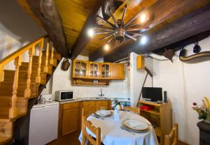 a kitchen with a table and a ceiling fan at Moinho Da Pena - Alojamento Local in Bairro