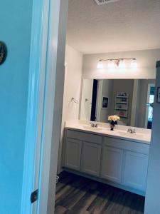 a bathroom with a sink and a mirror at Cheerful three-bedroom home in San Antonio