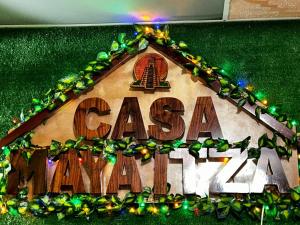 a gingerbread house with a sign that says casa mariana at Casa Maya Itza in Flores