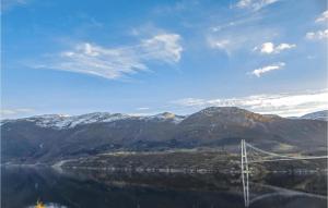 a bridge over a body of water with mountains at 3 Bedroom Pet Friendly Home In Vallavik in Vangsbygd