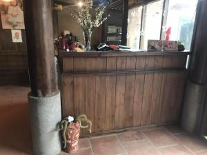 a wooden bar with a counter in a room at Little Ta Van Homestay in Sa Pa