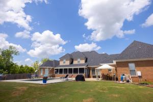 a large house with a large yard in front of it at SoulBeatz Country Mini Mansion w/ Pool & Putting Green in Hope Hull