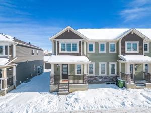 a house with snow in front of it at Stylish 3BR Townhouse by Airport in Calgary