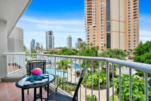 a balcony with a view of a pool and buildings at Markham Court in Gold Coast
