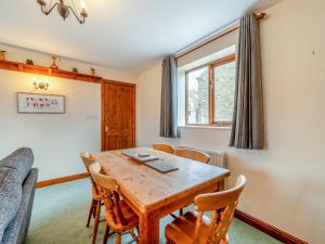 a dining room with a wooden table and chairs at Stable Cottage - Uk42936 in Rosedale Abbey