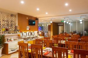 a dining room with tables and chairs in a restaurant at THANH TAI HOTEl 1 in Ho Chi Minh City
