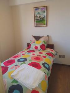a bedroom with a bed with a colorful comforter at Nico&Style Apartment VIP in La Paz