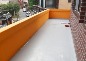 a balcony with an orange railing and a street at Bird Village Guesthouse Rook in Ulsan