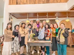 a group of people standing around a table at Maison de Sapa Villa in Sa Pa