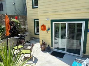 a patio with two chairs and an open door at Beautiful Condo in Sun Drenched Garden in San Francisco