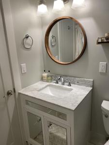 a bathroom with a sink and a mirror at Beautiful Condo in Sun Drenched Garden in San Francisco