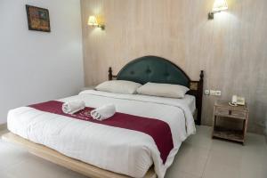 Postel nebo postele na pokoji v ubytování Abian Biu Mansion