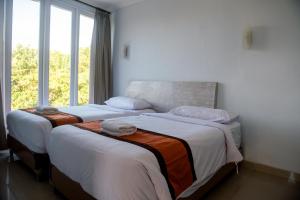 Postel nebo postele na pokoji v ubytování Abian Biu Mansion