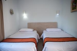 Postel nebo postele na pokoji v ubytování Abian Biu Mansion
