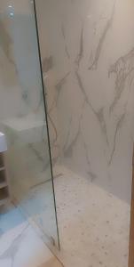 a glass shower in a room with a marble wall at Luxury Studio Princess in Casablanca