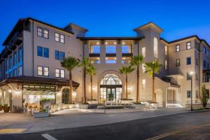 an exterior view of a building with palm trees at Locale Menlo Park in Menlo Park