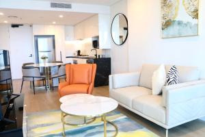 a living room with a couch and a table at Kooii Apartments in Brisbane