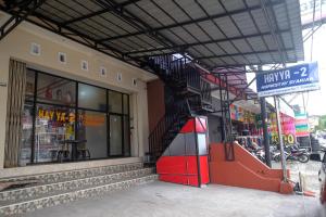 a store front of a building with a fire escape at RedDoorz Syariah near Alun Alun Wonosobo 3 in Wonosobo