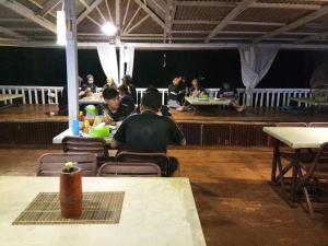 un grupo de personas sentadas en mesas en un restaurante en Long Beach Garden, en Kampung Kuala Besut