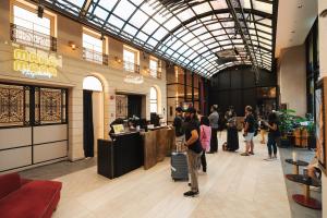 a group of people standing in a shopping mall at Scarletz KLCC Apartments by soulasia in Kuala Lumpur