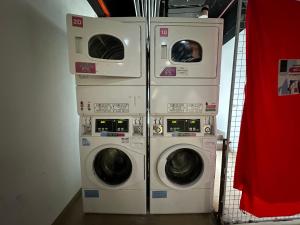 three washing machines are stacked on top of each other at Manhattan Suites Stay In 4pax in Kota Kinabalu