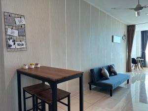 a dining room with a table and a blue chair at Manhattan Suites Stay In 4pax in Kota Kinabalu