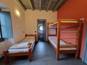 two bunk beds in a room with a hallway at Ostello Costa Alta in Monza
