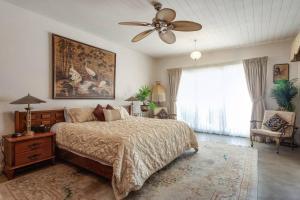 a bedroom with a bed and a ceiling fan at Shangri La in Goolwa South