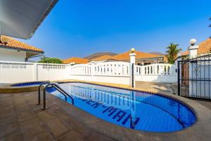 a swimming pool in the backyard of a house at Private 4 Bedroom Pool Villa NG411 in Hua Hin