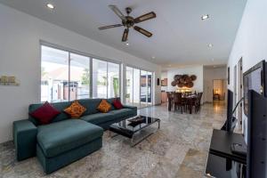 a living room with a couch and a ceiling fan at Private 4 Bedroom Pool Villa NG411 in Hua Hin