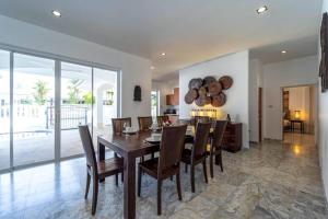 a kitchen and dining room with a table and chairs at Private 4 Bedroom Pool Villa NG411 in Hua Hin