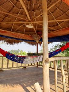 a hammock in a tent with a view of the ocean at Scorpion Wings Eco-Resort in Ban Na Nga