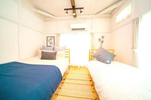 a bedroom with two beds and a window at Smile STAY Shin Nakano/ Vacation STAY 8453 in Tokyo