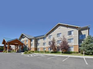 a large apartment building with a parking lot at Clubhouse Inn in West Yellowstone