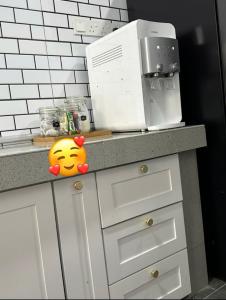 a kitchen counter with a microwave on top of it at Aisyah homestay islam shj in Tanah Merah