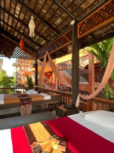 a bedroom with two beds and a hammock at Rainforest Huahin Village Hotel in Hua Hin